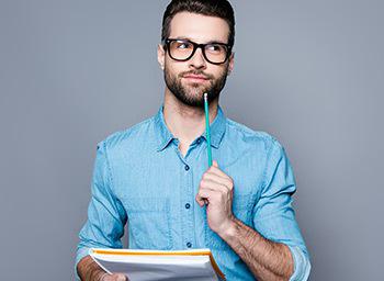 an online blackjack player thinks while holding a pencil